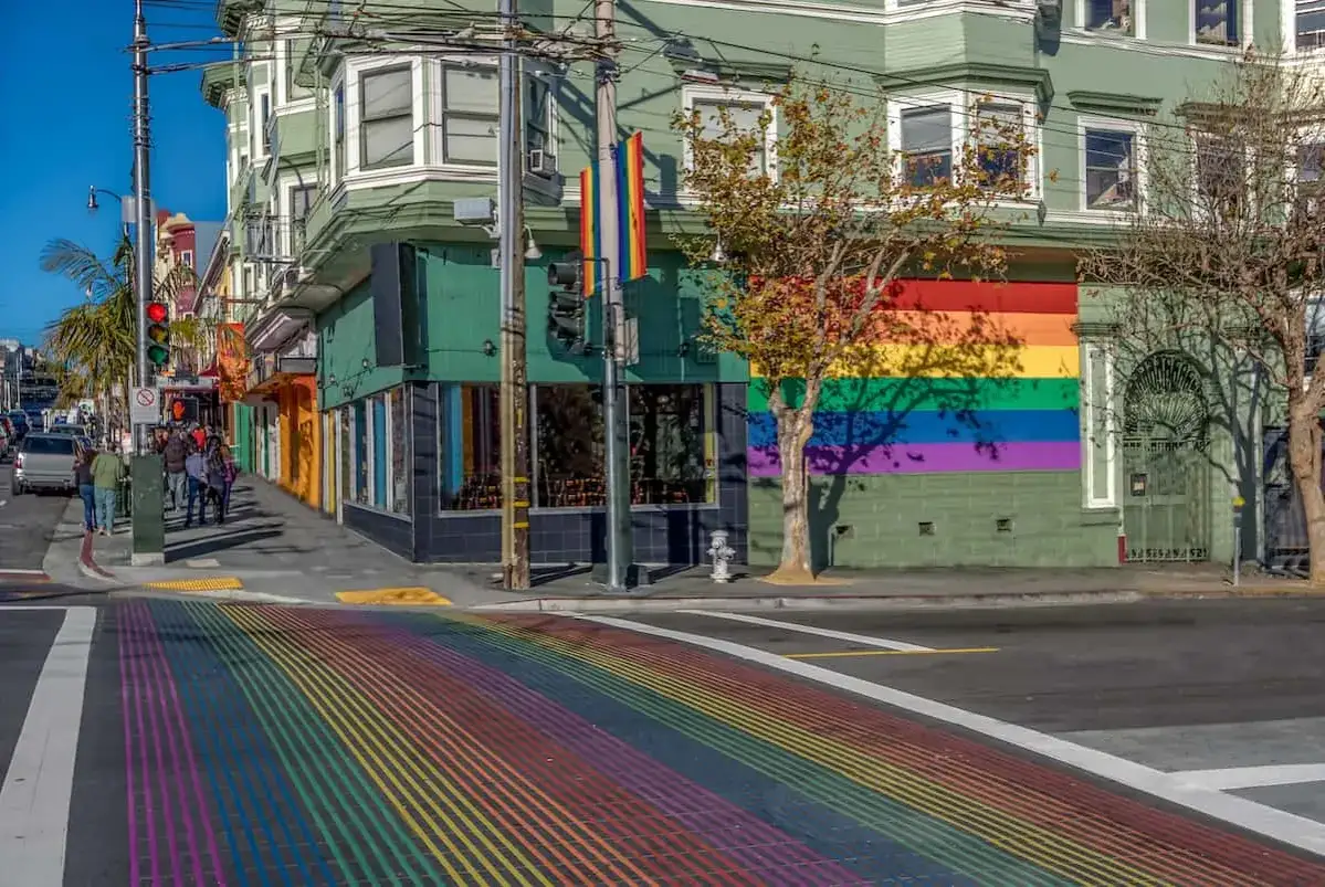 Rainbow crosswalk and building mural in San Francisco, a vibrant scene perfect for a gay bed and breakfast stay.